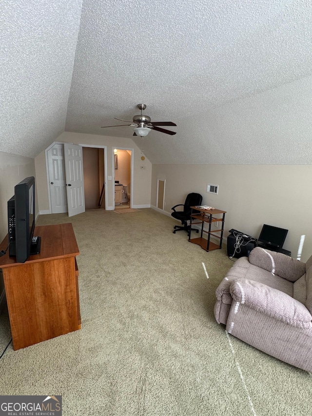 bonus room with vaulted ceiling, carpet, ceiling fan, and a textured ceiling