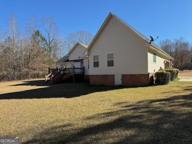 view of side of property with a lawn and a wooden deck