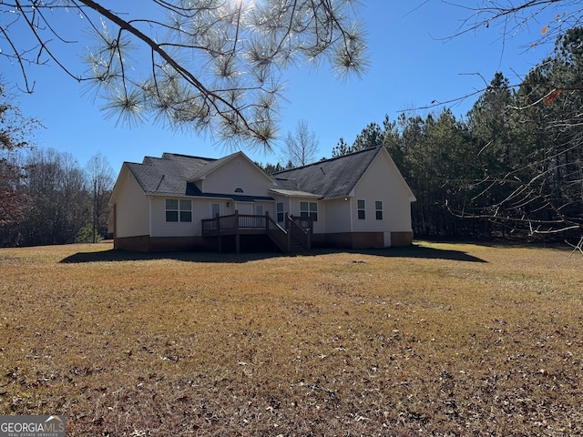 exterior space featuring a deck and a front lawn