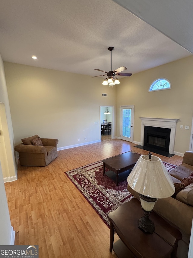 living room featuring light wood-type flooring and ceiling fan