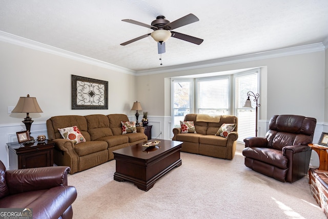 living room with crown molding, light colored carpet, and ceiling fan