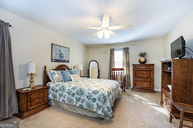 bedroom with ceiling fan and light colored carpet