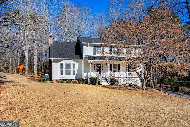 front of property with a porch and a front yard