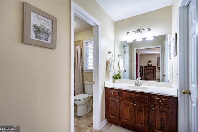 bathroom with vanity, toilet, and walk in shower