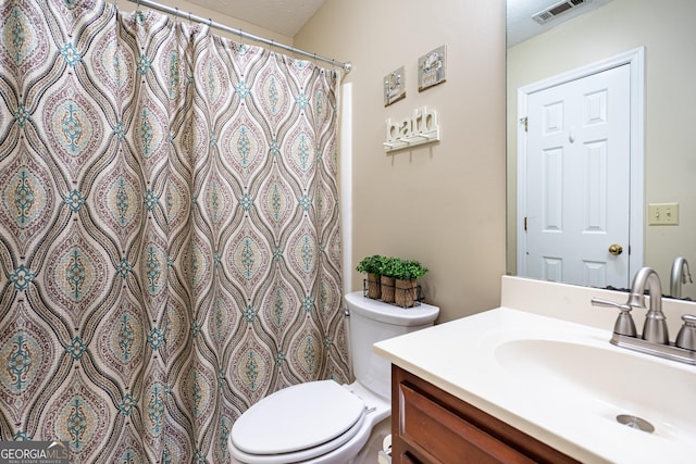 bathroom featuring vanity and toilet