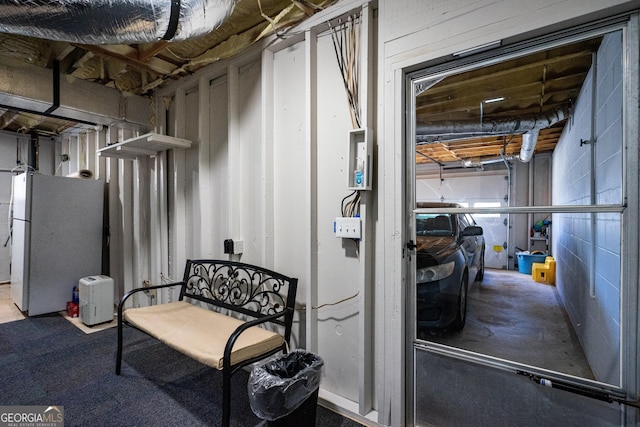 basement with white refrigerator