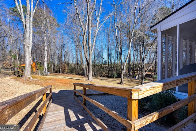 view of yard featuring a wooden deck and a sunroom