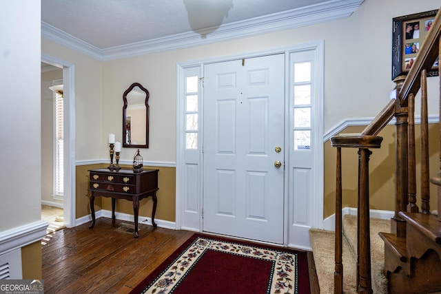 entryway featuring ornamental molding and dark hardwood / wood-style floors