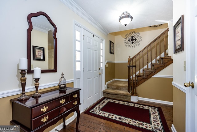 entrance foyer with dark hardwood / wood-style flooring and crown molding