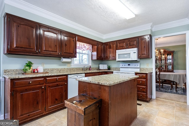 kitchen featuring crown molding, white appliances, a textured ceiling, and a kitchen island