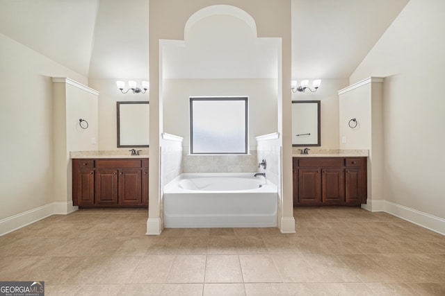 bathroom featuring a washtub, a chandelier, vaulted ceiling, and vanity