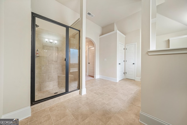 bathroom with a shower with door