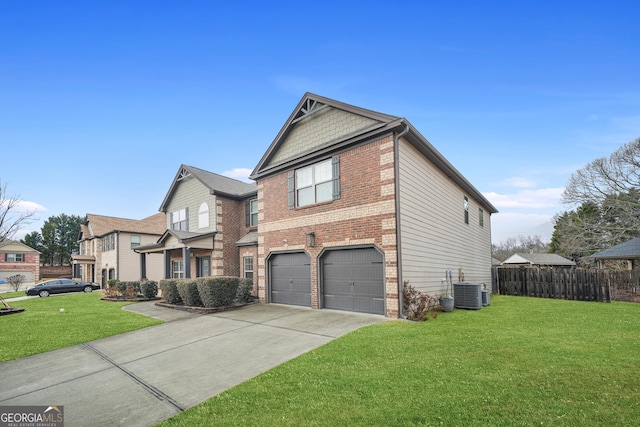 view of front of property featuring a garage, central AC unit, and a front yard