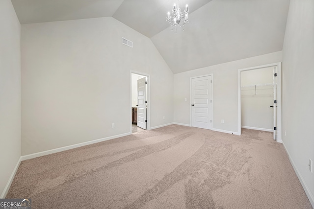 interior space with a notable chandelier and lofted ceiling