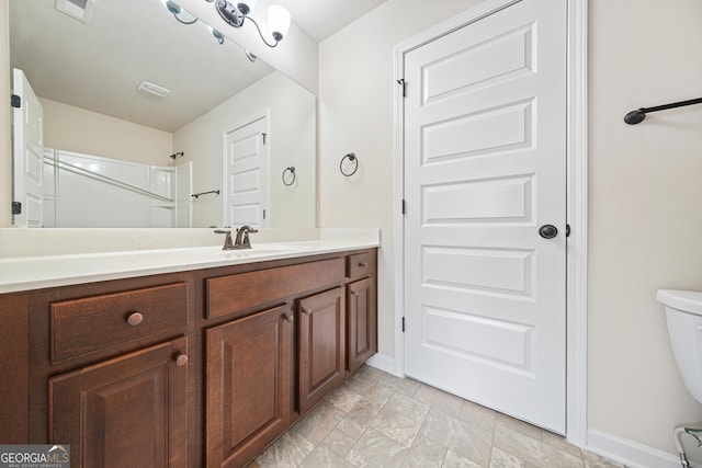 bathroom featuring vanity and toilet