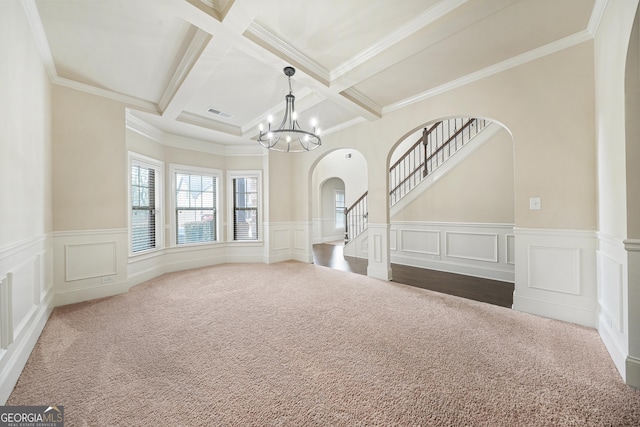 empty room with carpet floors, beamed ceiling, and coffered ceiling