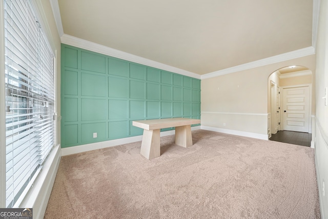 interior space featuring ornamental molding and dark colored carpet