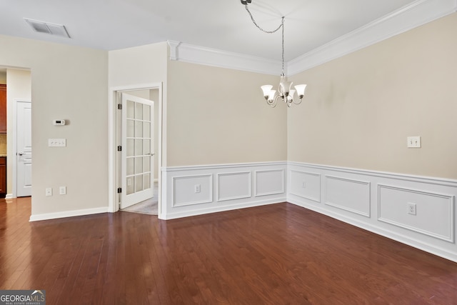 unfurnished room with a notable chandelier, crown molding, and dark hardwood / wood-style floors