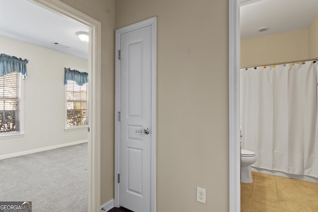 bathroom with curtained shower and toilet