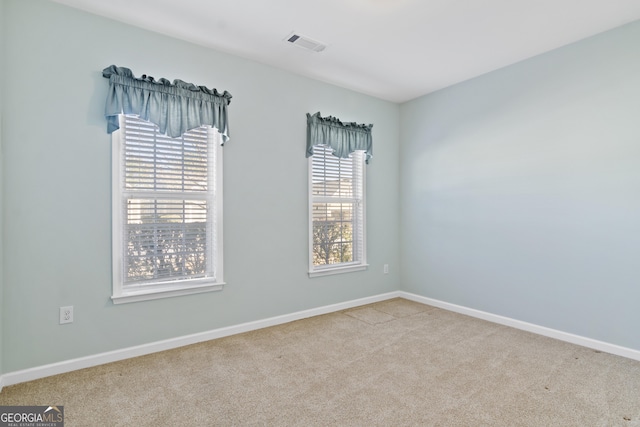 spare room with light colored carpet