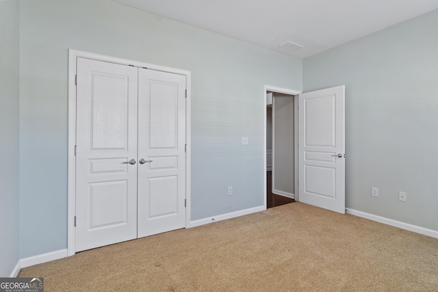 unfurnished bedroom with carpet flooring and a closet