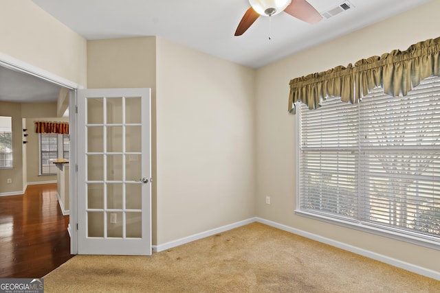 empty room with ceiling fan and carpet flooring