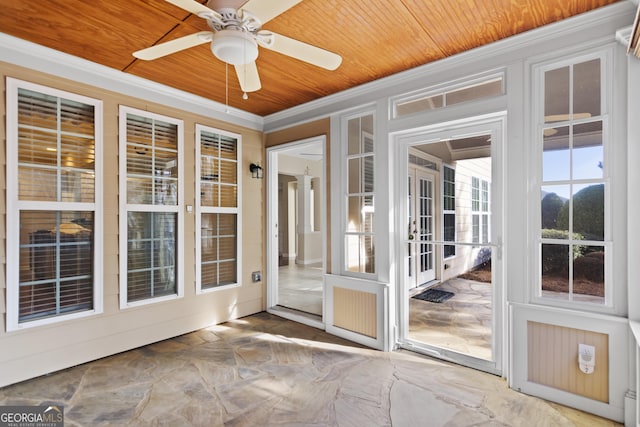 unfurnished sunroom featuring ceiling fan and wooden ceiling