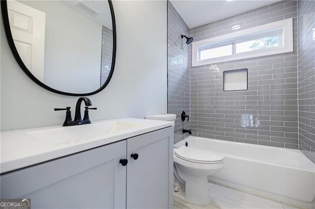 bathroom with tile patterned flooring, visible vents, toilet, shower / bath combination, and vanity