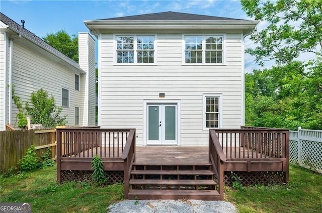 back of house with french doors, a deck, and fence