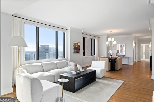 living area with crown molding, baseboards, wood finished floors, and a city view