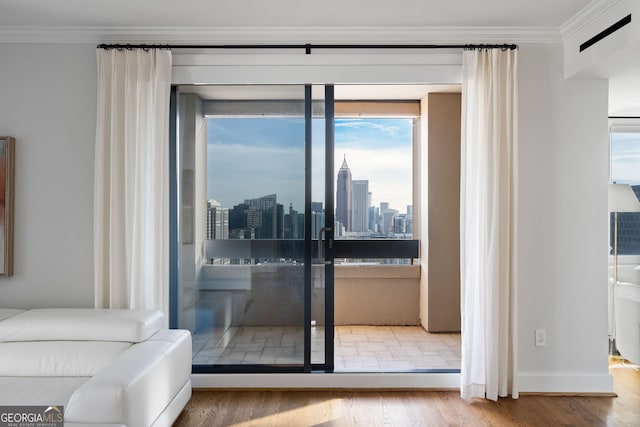 doorway featuring a view of city, crown molding, and wood finished floors