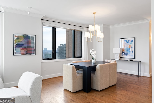 dining room with a view of city, crown molding, an inviting chandelier, wood finished floors, and baseboards