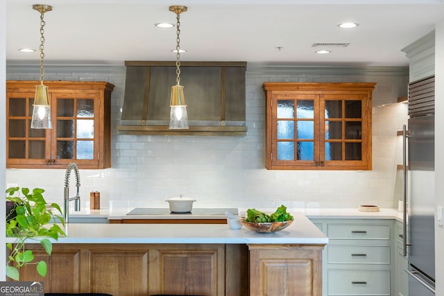 kitchen featuring glass insert cabinets, light countertops, and a sink