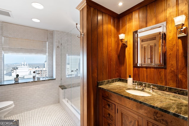 bathroom with visible vents, toilet, a stall shower, vanity, and tile patterned floors