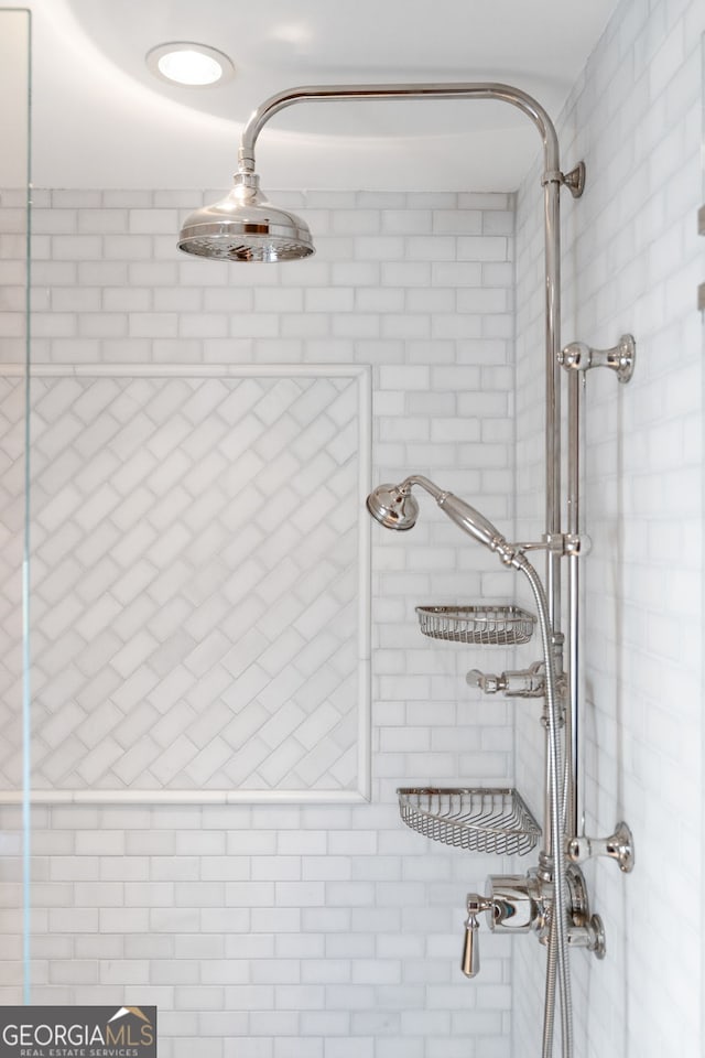 bathroom with tiled shower