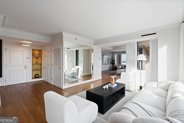 living area featuring ornamental molding, dark wood-type flooring, and baseboards