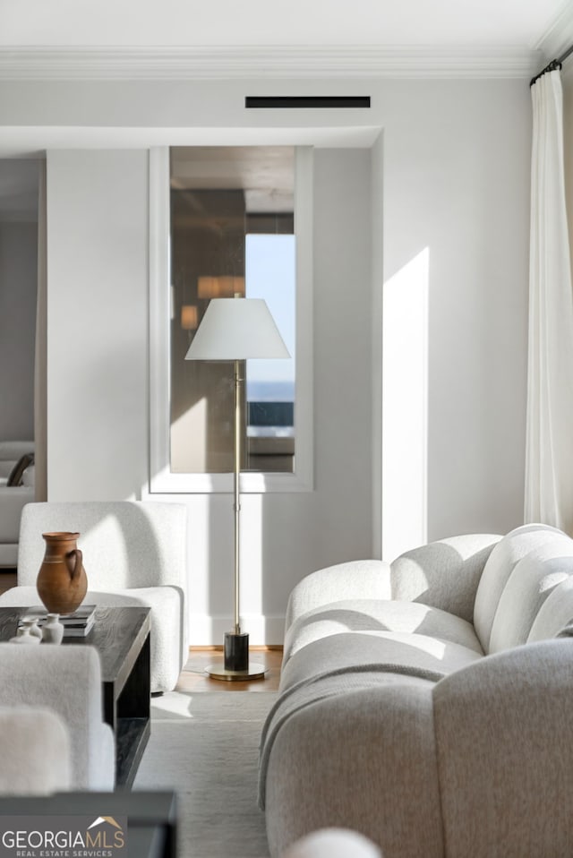 bedroom featuring ornamental molding and wood finished floors