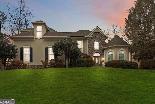 view of front of property with a lawn