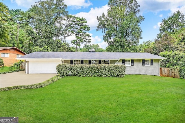 ranch-style house featuring a front yard and a garage