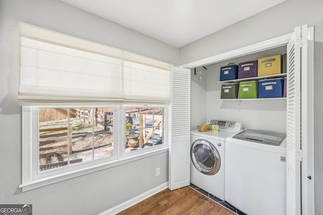 washroom with dark hardwood / wood-style flooring and separate washer and dryer