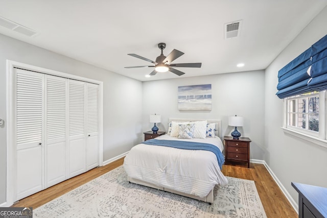 bedroom featuring hardwood / wood-style floors, a closet, and ceiling fan