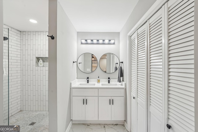 bathroom with vanity and tiled shower