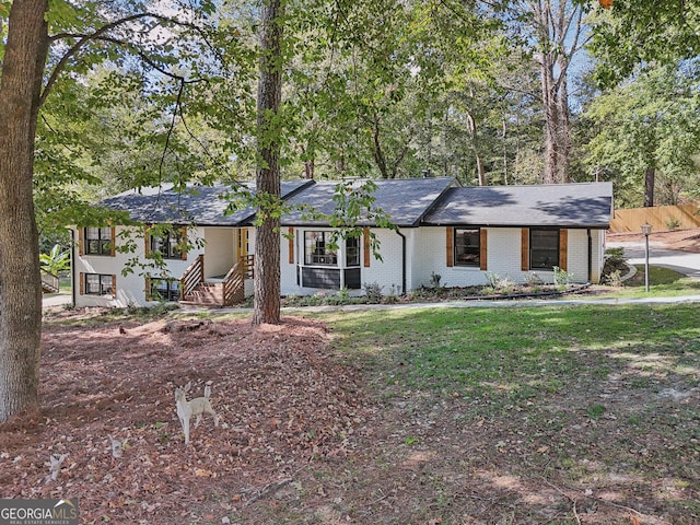 ranch-style house with a front lawn