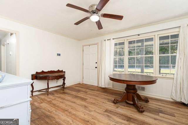 interior space with ceiling fan, hardwood / wood-style floors, crown molding, and a healthy amount of sunlight