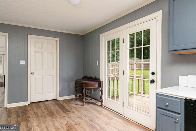 doorway with light hardwood / wood-style flooring and crown molding