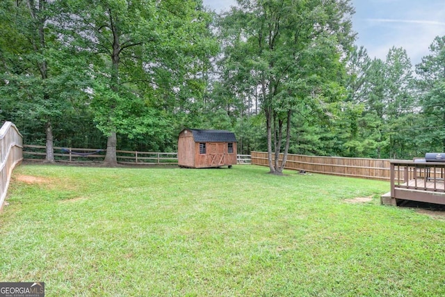 view of yard featuring a deck and a shed