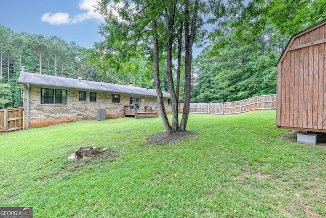 view of yard featuring central AC unit and a wooden deck