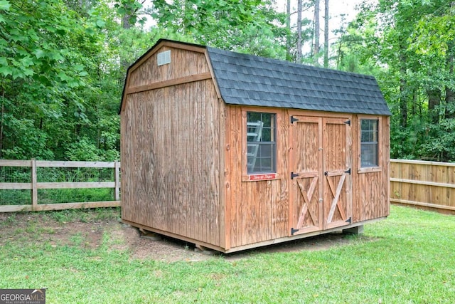 view of outbuilding featuring a yard