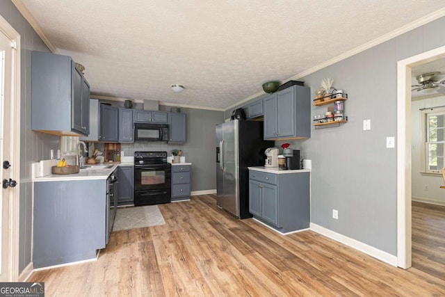 kitchen with black appliances, a textured ceiling, light hardwood / wood-style flooring, and ornamental molding