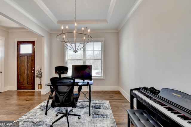 office area featuring a raised ceiling, crown molding, dark hardwood / wood-style floors, and a chandelier